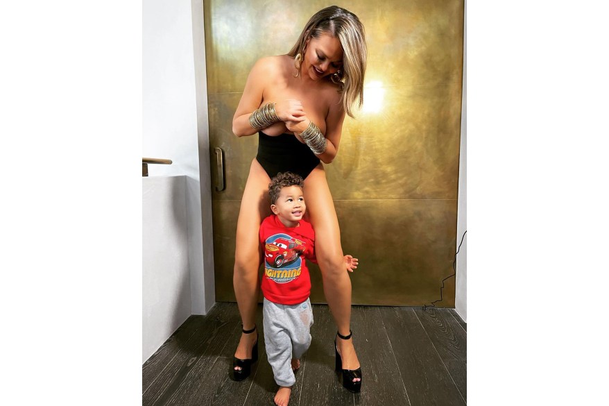 “Please move, mommy is trying to be thirsty,” jokes Chrissy Teigen, while her son Miles, 2, interrupts her sexy photo shoot.