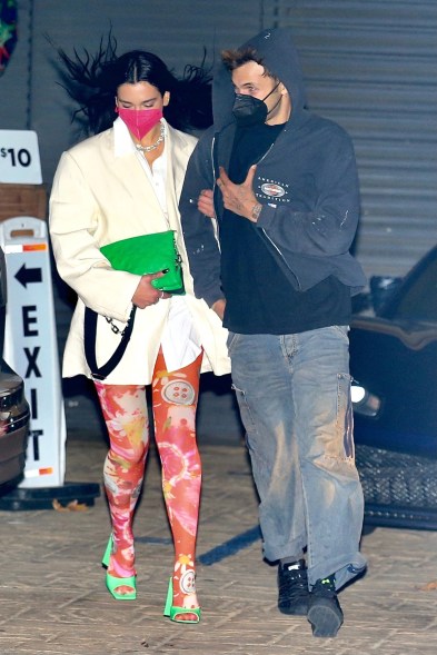 Dua Lipa and boyfriend Anwar Hadid look wind-swept as they hit date spot Nobu in Malibu, California.