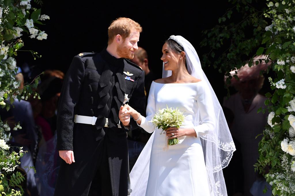 Britain's Prince Harry, Duke of Sussex and his wife Meghan, Duchess of Sussex leave from the West Door of St George's Chapel.