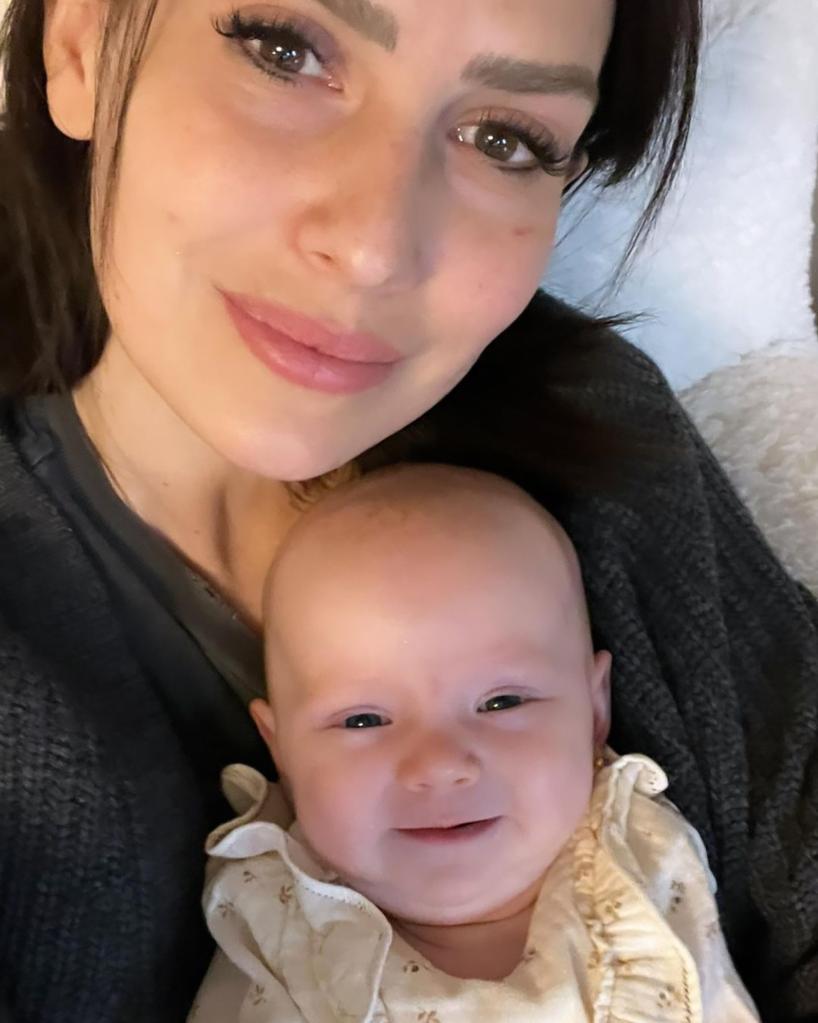 Hilaria Baldwin smiles holding daughter Lucía