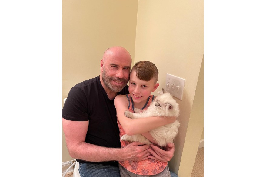 John Travolta and his son Ben, 10, whose mom is the late Kelly Preston, welcome a new cat named Crystal into their family.