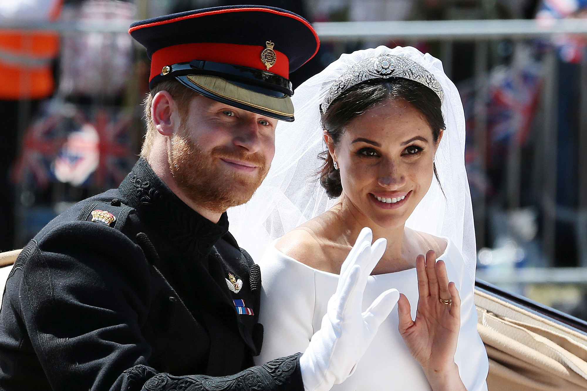 Prince Harry and Meghan Markle wave from the Ascot Landau Carriage after their wedding ceremony on May 19, 2018.