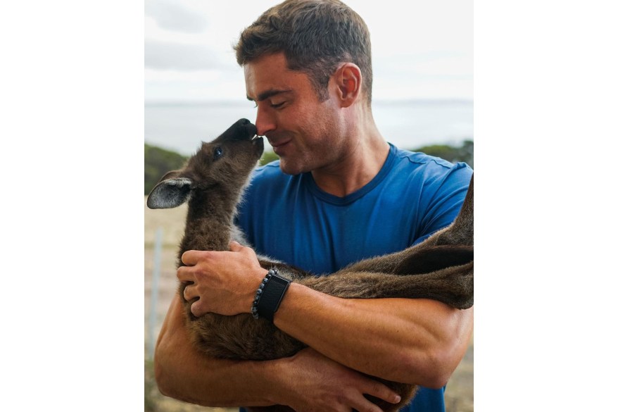 Zac Efron cuddles up to a baby kangaroo while filming Season 2 of his Netflix show “Down to Earth” in Australia.
