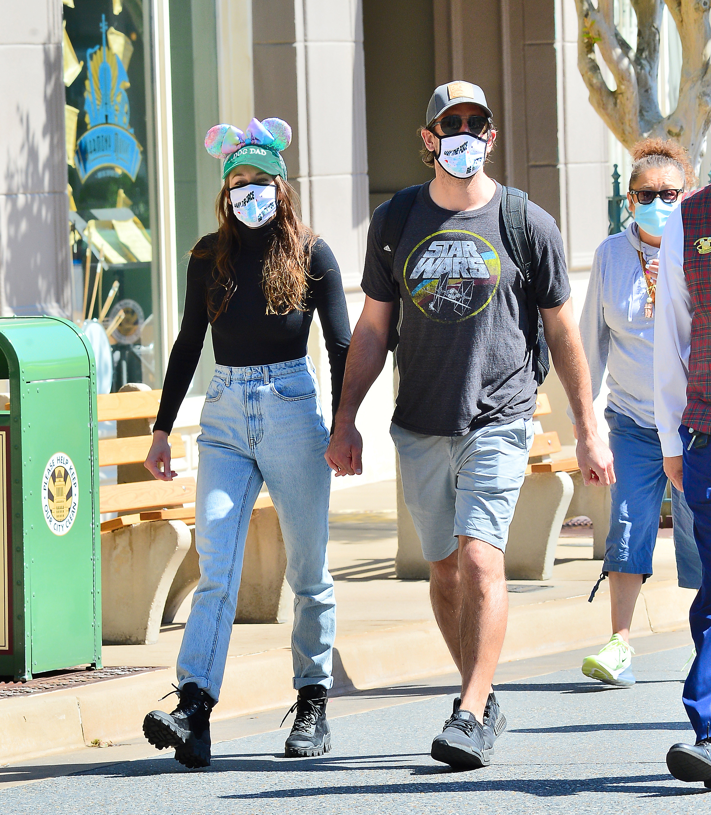 Engaged couple Shailene Woodley and Aaron Rodgers hold hands in Disney World.