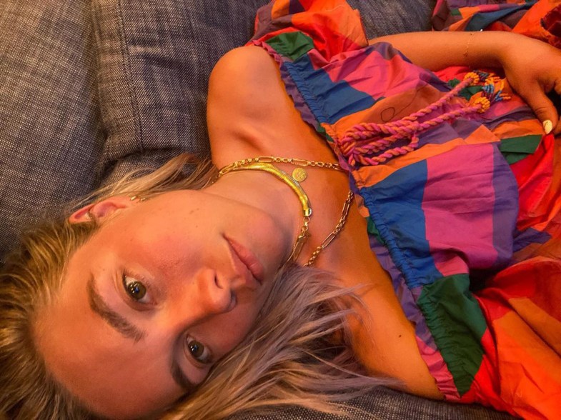 Florence Pugh shows off her tan while rocking a colorful sun dress in an Instagram photo.