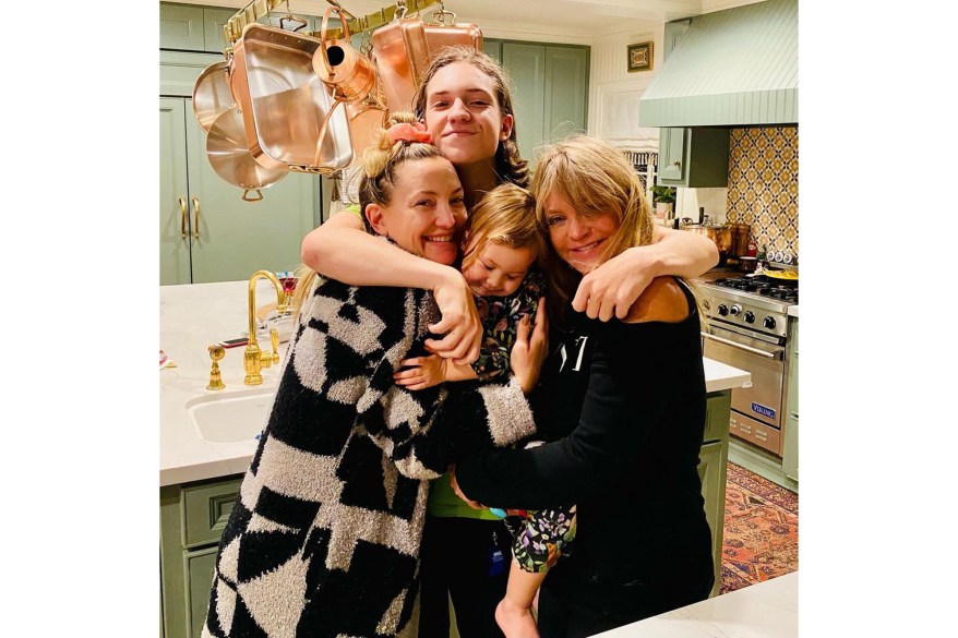 Kate Hudson (from left), her son Ryder, 17, daughter Rani, 2, and mom Goldie Hawn share a group hug.