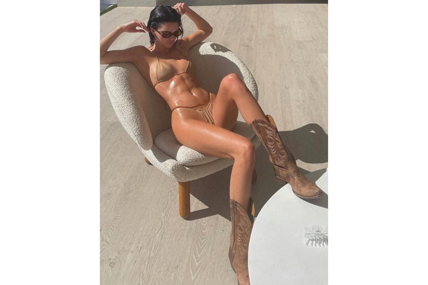 Kendall Jenner hangs out at home in a pair of cowboy boots and a string bikini, as you do.