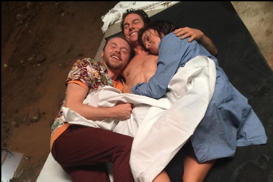 Simon Pegg cuddles up with a shirtless Tom Cruise and Rebecca Ferguson while shooting the latest "Mission: Impossible."