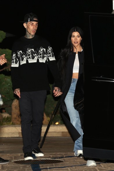 Travis Barker and Kourtney Kardashian hold hands on their way to dinner at Nobu in Malibu.