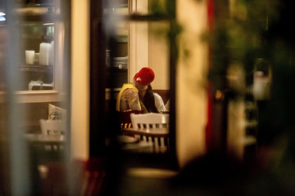 Kourtney Kardashian and Travis Barker kissing.