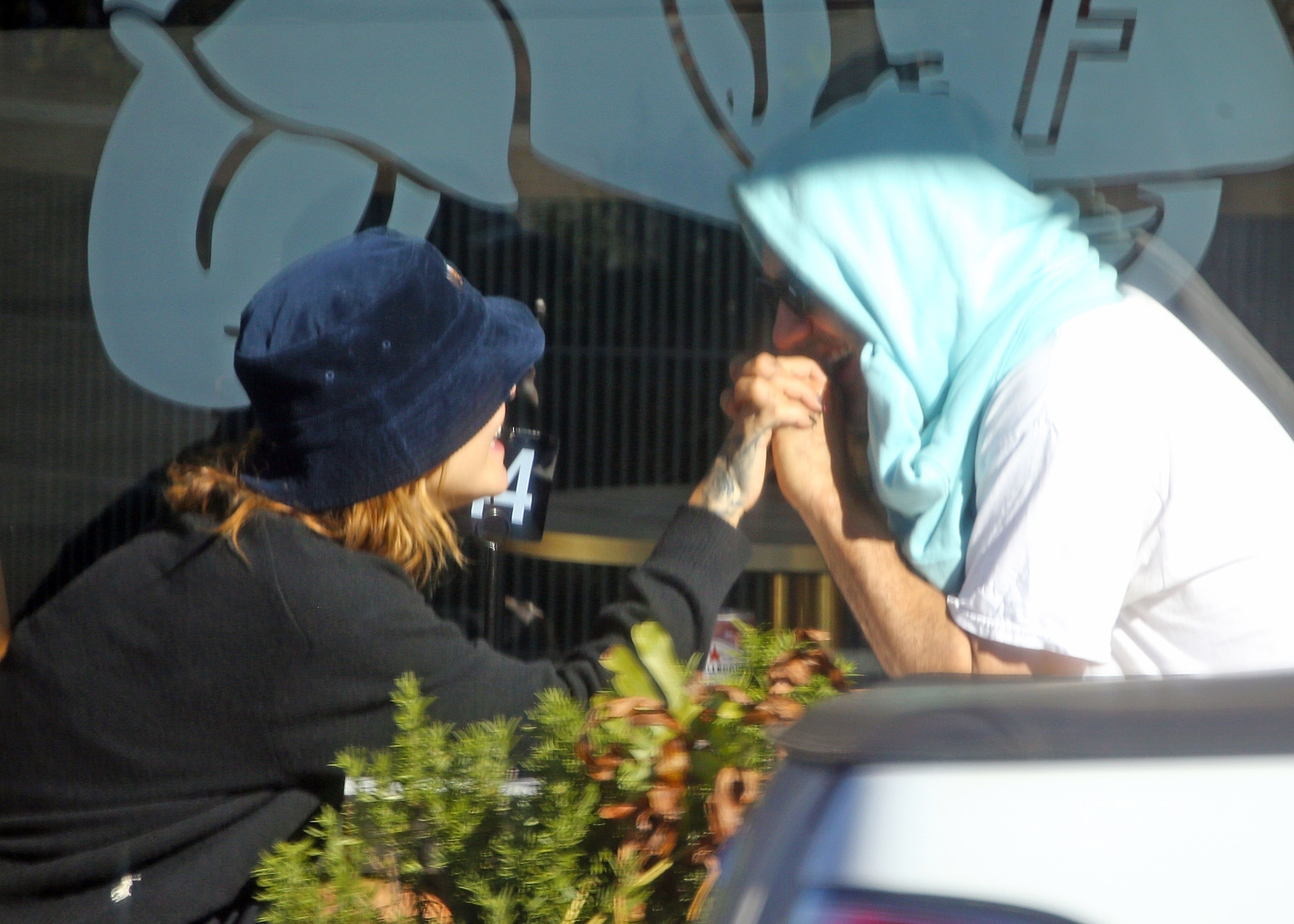 Taika Waititi holds Rita Ora's hand in Sydney.