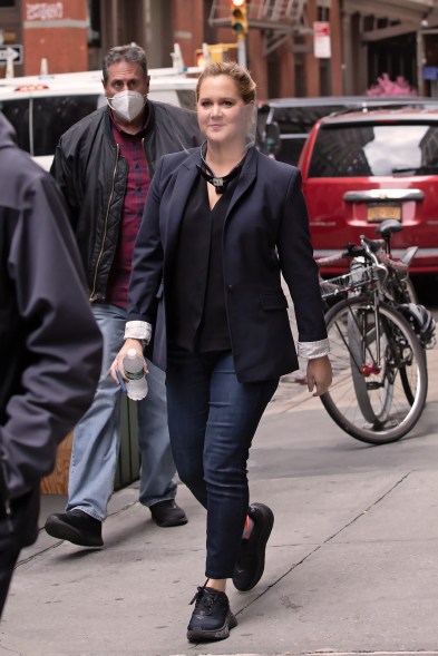 Amy Schumer wears a face shield while heading to set for "Life and Beth" in New York.