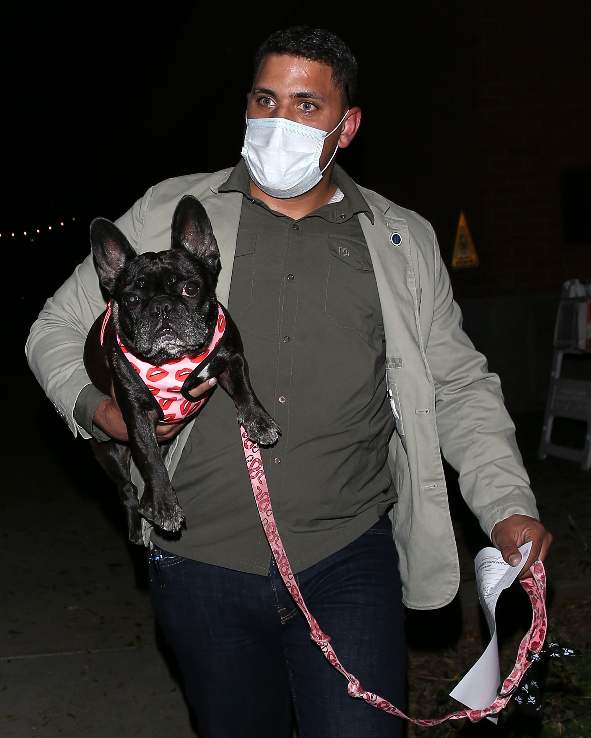 Lady Gaga's dog is picked up by her bodyguard at the Hollywood LAPD Station on Feb. 25, 2021.