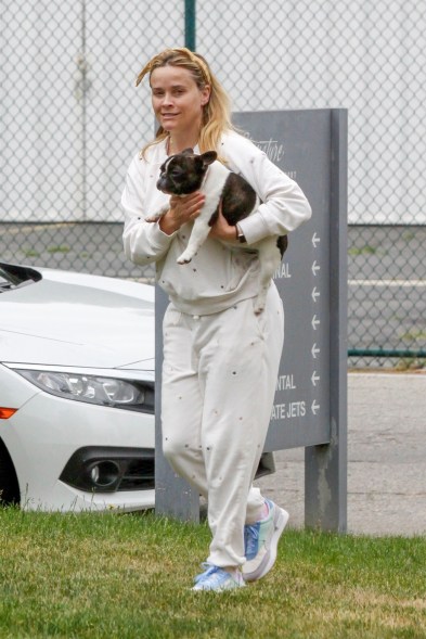 Reese Witherspoon looks casual while taking her dog for a walk in Los Angeles.