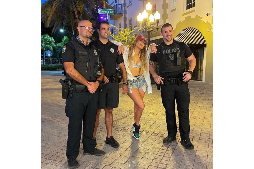 MIAMI VICE: Jennifer Lopez poses with local police officers in Florida.