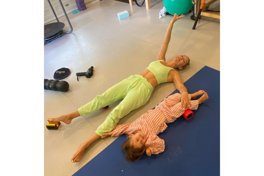 LET’S GET PHYSICAL: Kate Hudson and her daughter Rani, 2, stretch after working out together.