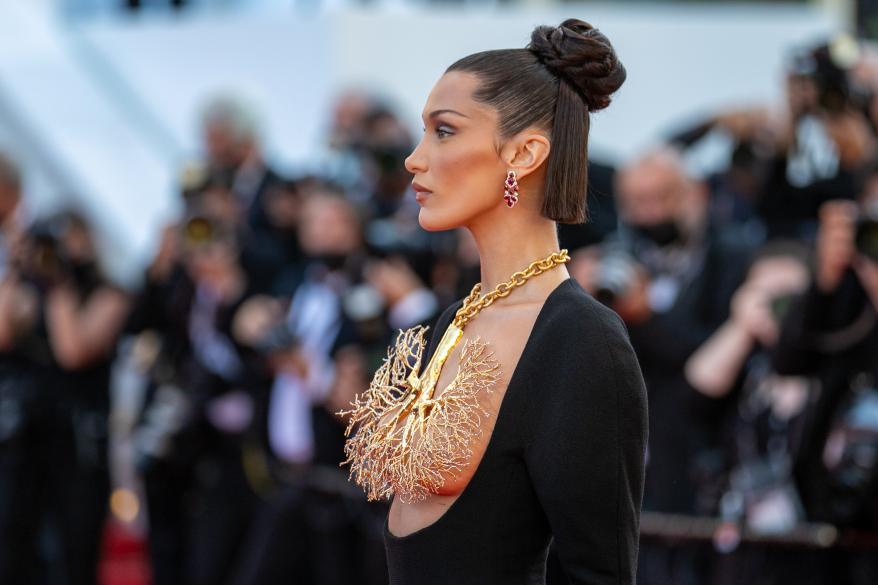 Bella Hadid wearing a gold, lungs-inspired necklace.