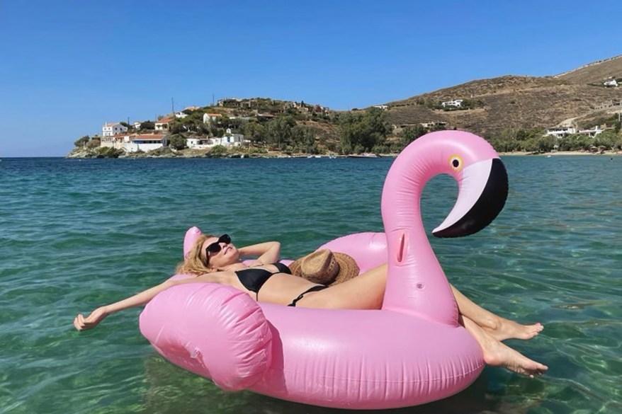 BIRD BATH: Heather Graham soaks up the sun on a huge pink flamingo floaty in Greece.