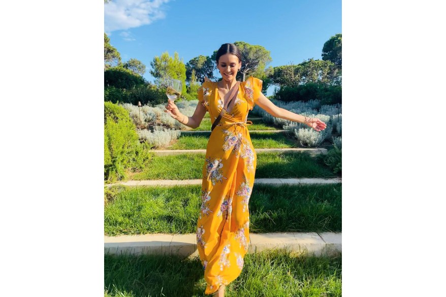 WINE AND ‘SAY CHEESE’: Actress Nina Dobrev flashes a sweet smile while enjoying a drink in the beautiful outdoors.