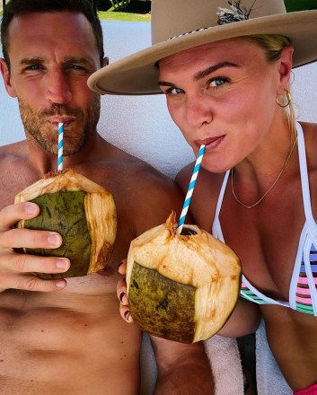 Brooks Laich and Katrín Tanja Davíðsdóttir drink out of coconuts.