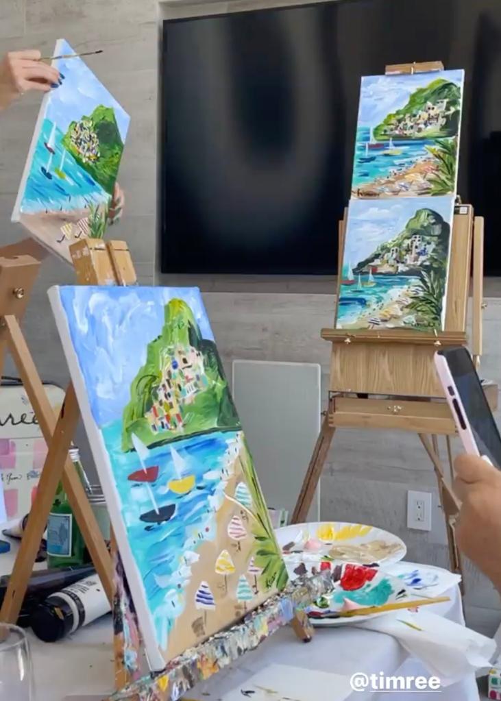 Three landscape paintings on mini easels.