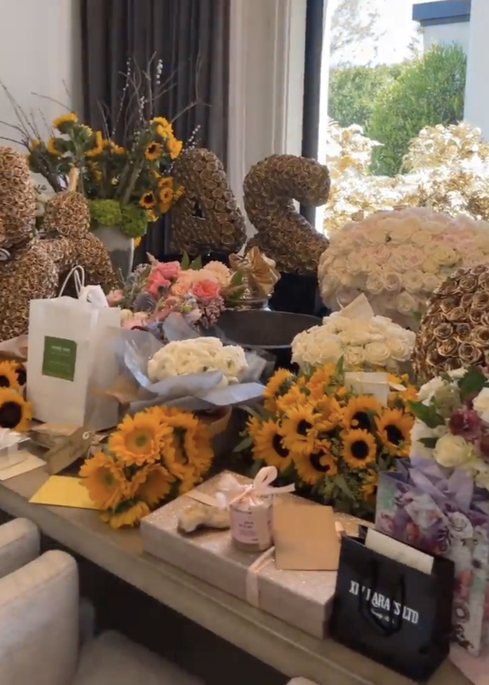 Kylie Jenner's table covered in flower bouquets.