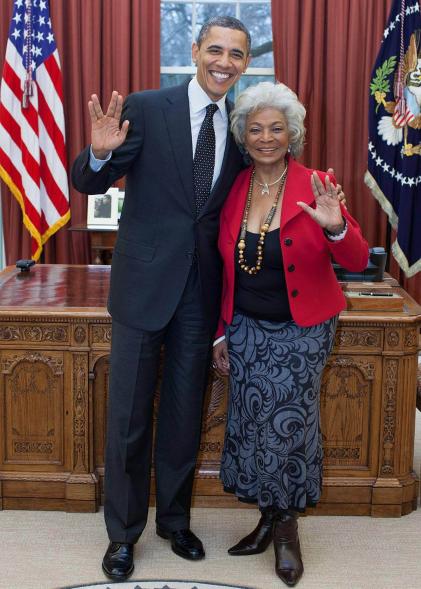 President Barack Obama poses with actress Nichelle Nichols giving the Vulcan salute of Star Trek fame in the Oval Office of the White House on Feb. 29, 2012, in Washington, DC.