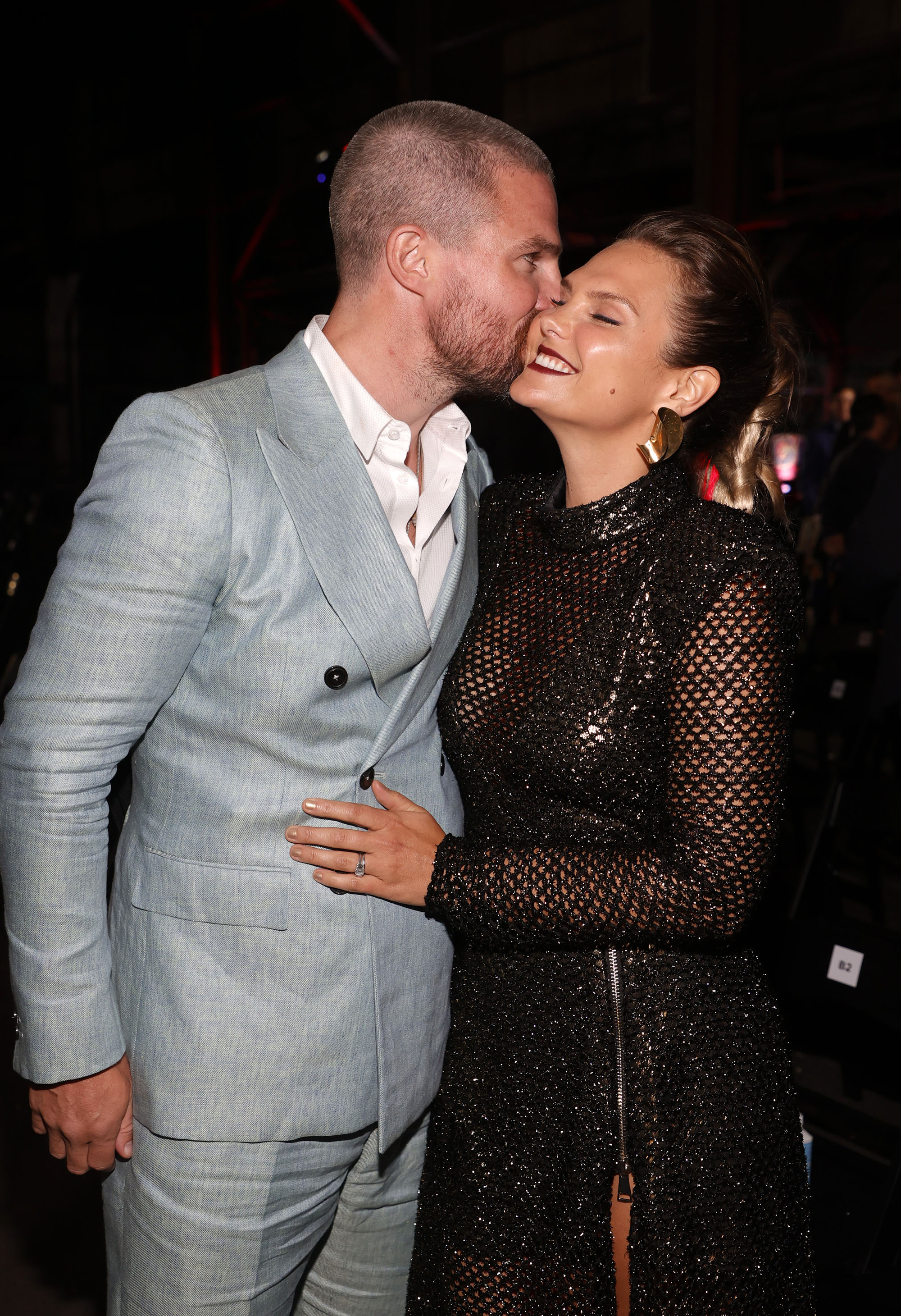 Stephen Amell and Cassandra Jean Amell kiss at the "Heels" afterparty.