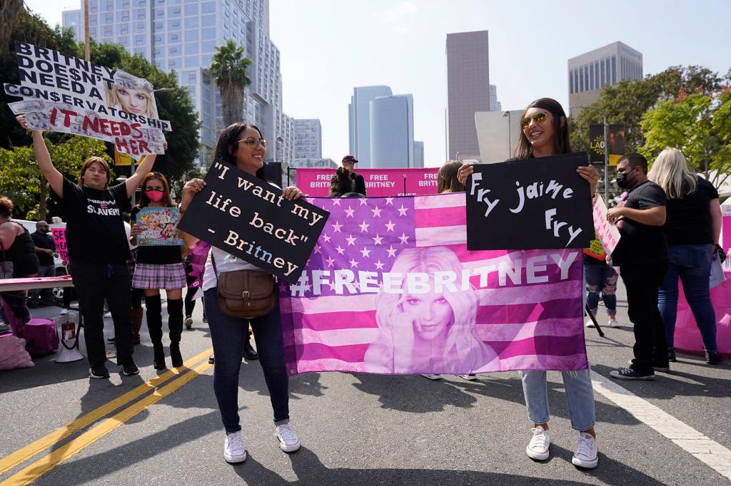 Britney Spears supporter Ashley Montano, left, and her sister-in-law Angela Montano demonstrate outside a hearing concerning the pop singer's conservatorship at the Stanley Mosk Courthouse, Wednesday, Sept. 29, 2021, in Los Angeles. A Los Angeles judge will hear arguments at a hearing Wednesday over removing Spears' father from the conservatorship that controls her life and money and whether the legal arrangement should be ended altogether. (AP Photo/Chris Pizzello)