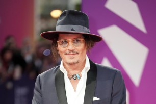 Johnny Depp smiles on the red carpet.