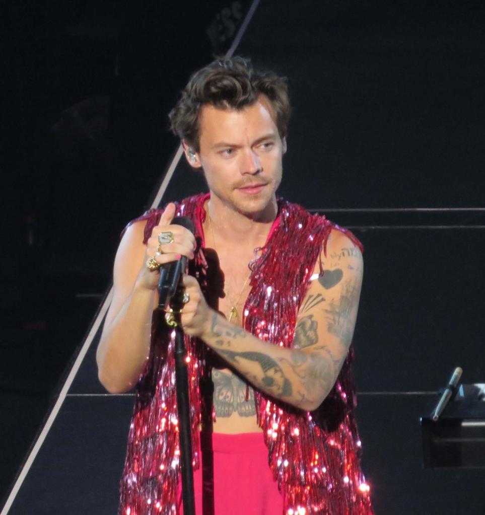 Harry Styles stands in front of a microphone stand during a concert in Las Vegas.