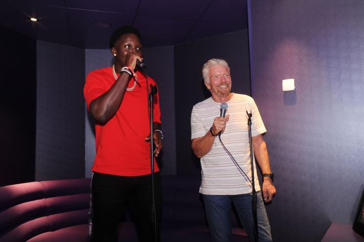 Richard Branson and Miami Heat star Victor Oladipo sing karaoke aboard Branson's new cruise ship.