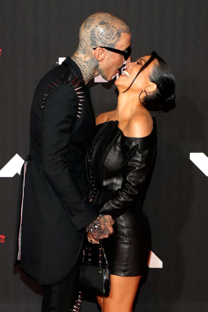 Travis Barker kissing Kourtney Kardashian on the red carpet at the MTV VMA's in 2021