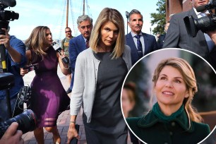 Lori Loughlin keeps her head down while walking through a crowd outside of the courthouse