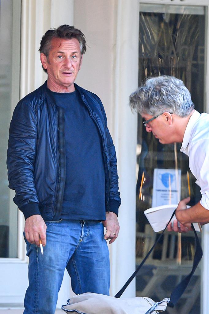 Sean Penn smoking a cigarette and wearing his wedding ring one day after Leila George filed to divorce him