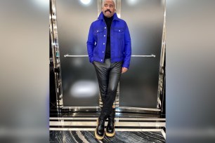 Steve Harvey posing in a blue jacket