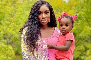 Dr. Wendy Osefo holding her daughter Kamrynn