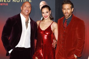 Dwayne "The Rock" Johnson, Gal Gadot and Ryan Reynolds coordinating in red outfits on the red carpet