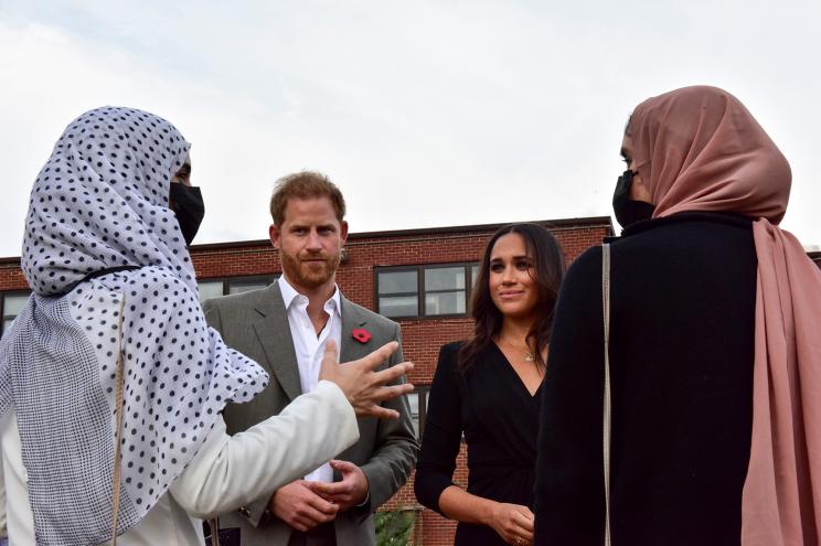 Prince Harry and Meghan Markle chatting with the mothers of Afghan refugee children