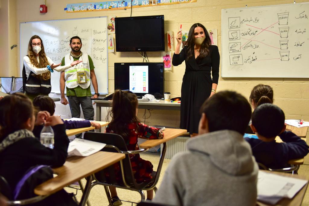 Meghan Markle holding up a red marker in a classroom full of Afghan refugee children in New Jersey