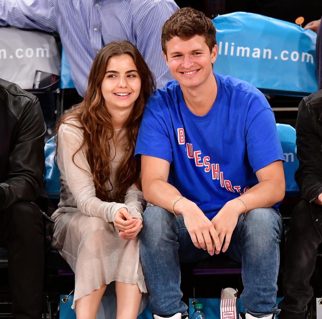 Violetta Komyshan and Ansel Elgort smiling together at an NBA game.