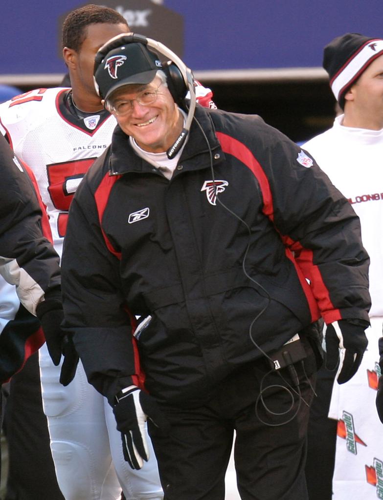 Dan Reeves standing on a football field.