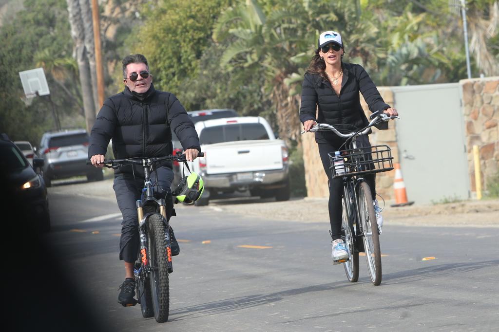 simon cowell and Lauren Silverman riding bikes in malibu