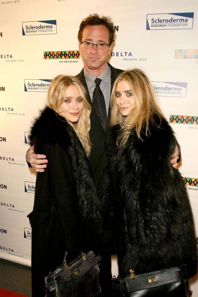 Mary-Kate and Ashley Olsen and Bob Saget on a red carpet in 2010.