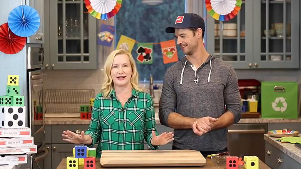 A screenshot of Angela Kinsey and Joshua Snyder on their YouTube cooking channel.