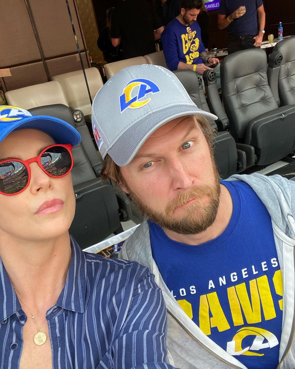 Charlize Theron at the Super Bowl with her friend's husband.