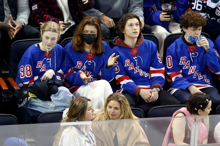 Zendaya, Tom Holland and Hunter Schafer sitting together at a Rangers game.