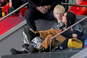 Machine Gun Kelly and Megan Fox watch the NHL All-Star Game.