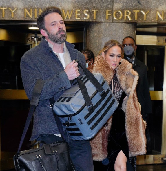 Ben Affleck carries bags next to Jennifer Lopez