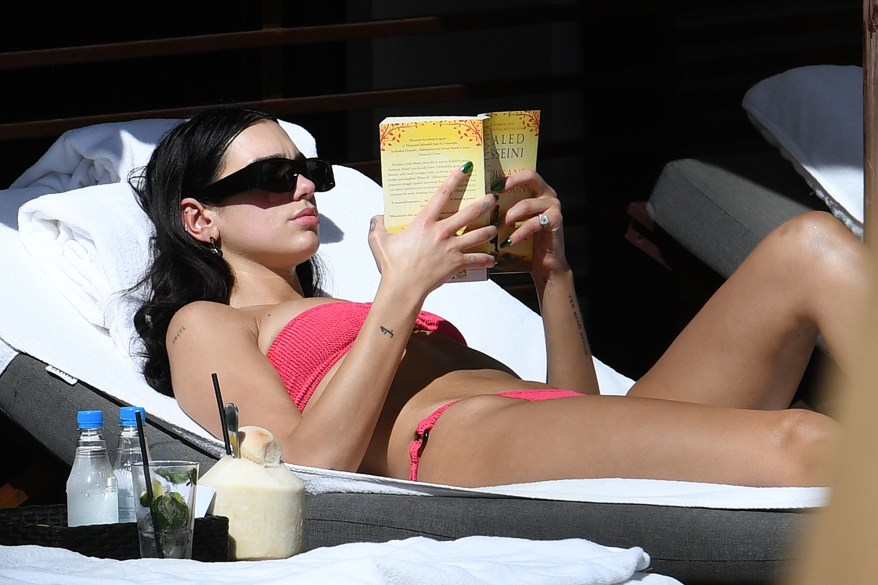 Dua Lipa reads in a bikini